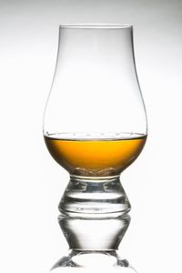 Close-up of beer glass against white background