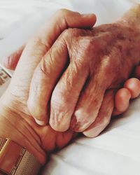 Close-up of woman hand with tattoo on bed