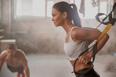 Young woman exercising in gym