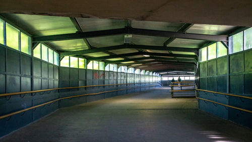 Empty corridor in illuminated building