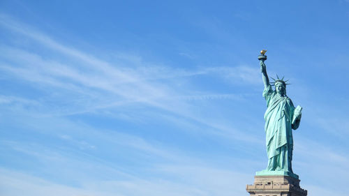 Low angle view of statue against cloudy sky