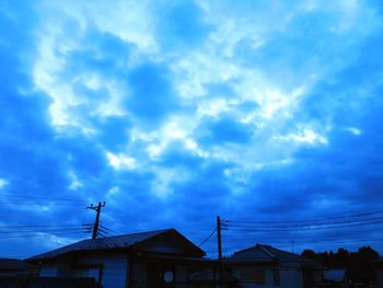 Low angle view of silhouette buildings against sky