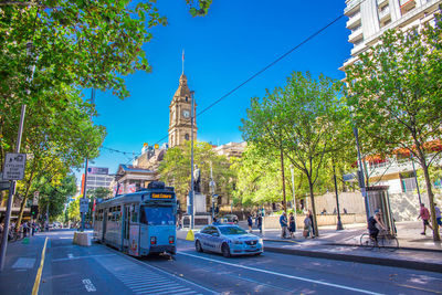 View of city street and buildings against sky
