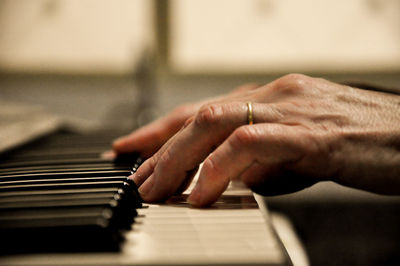 Cropped hands playing piano