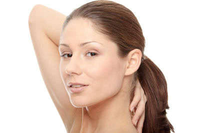 Close-up portrait of young woman against white background
