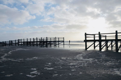 Pier on sea against sky