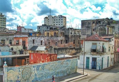 Buildings against cloudy sky