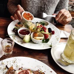 Cropped image of man eating food on table