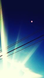 Low angle view of vapor trails in blue sky