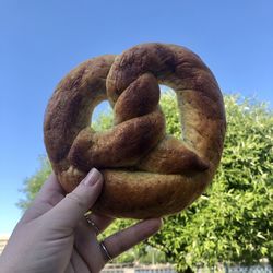 Close-up of hand holding bread against clear sky