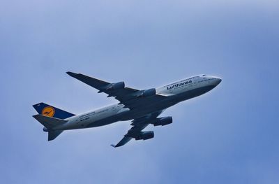 Low angle view of airplane flying against clear sky