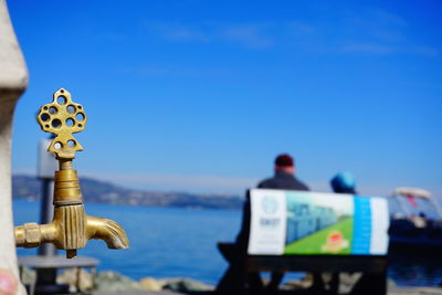 Close-up rear view of blue sea against clear sky