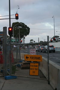 Road sign against cloudy sky