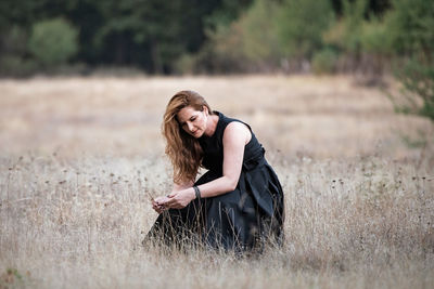 Young woman smiling on field