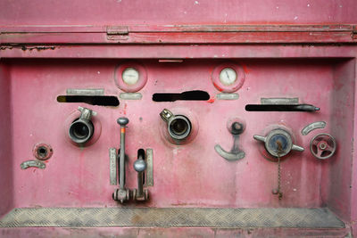 Machinery amidst red wall