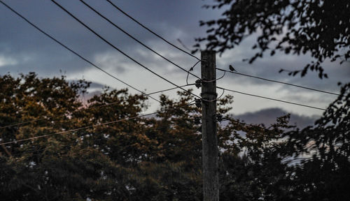 Low angle view of electricity pylon against sky