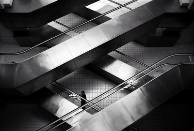 High angle view of people walking on staircase in building