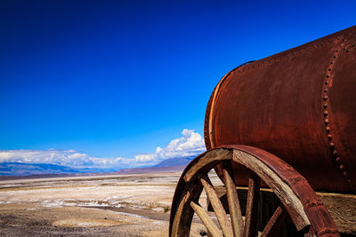 Old abandoned truck on mountain against blue sky
