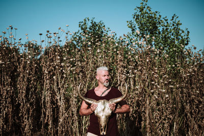 Portrait of man standing in field