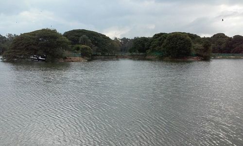 Scenic view of lake against cloudy sky