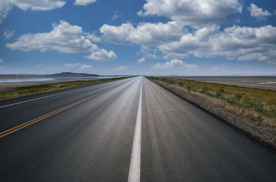 Empty road along countryside landscape