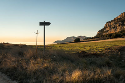 Scenic view of field against clear sky during sunset