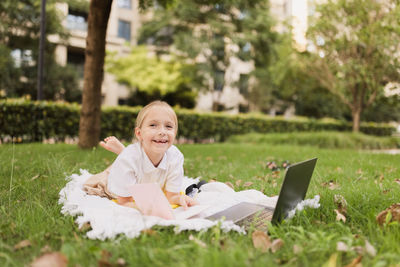 Portrait of smiling girl sitting on field