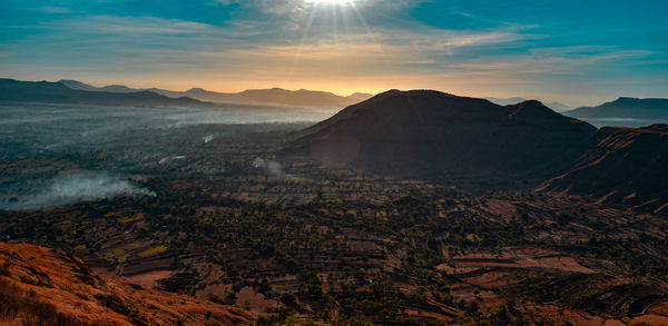 Scenic view of mountains against sky during sunset