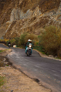 Man riding motorcycle on road