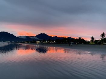 Scenic view of lake against orange sky