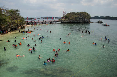 People in water against sky