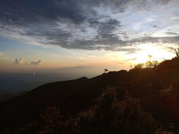 Scenic view of silhouette mountains against sky at sunset