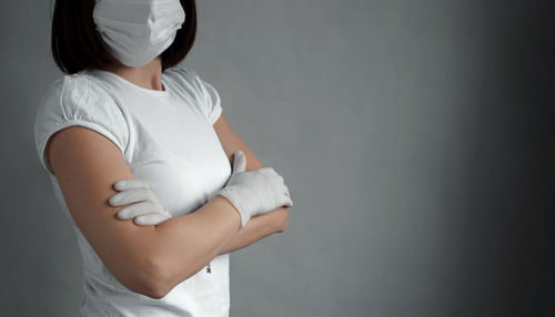 Midsection of woman standing against white background
