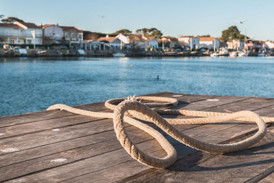 Boats moored at pier by sea against sky