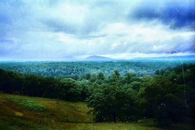 Scenic view of calm sea against mountain range