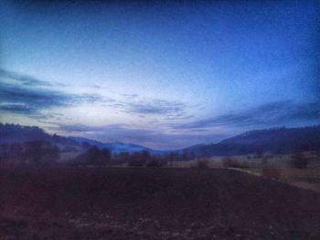 Scenic view of field against sky at dusk