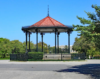 View of gazebo in park against blue sky