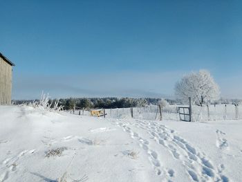 Tranquil view of snow covered landscape against sky