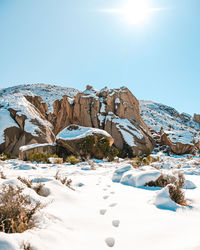 Scenic view of snowcapped landscape against clear blue sky