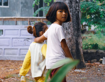 Side view of young woman standing on field