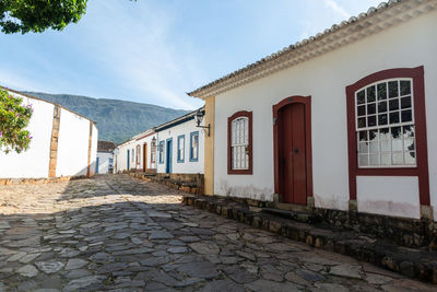 Alley amidst buildings in city against sky