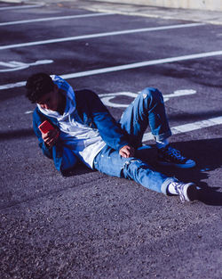 High angle view of man lying on road