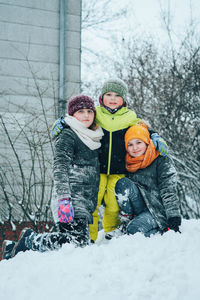 Siblings on snow during winter