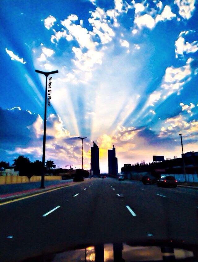 transportation, road, car, sky, sunset, the way forward, road marking, cloud - sky, land vehicle, street, street light, mode of transport, cloud, diminishing perspective, built structure, building exterior, blue, traffic, architecture, no people