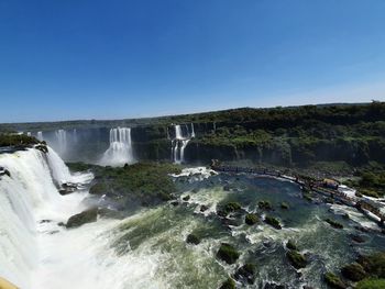 Scenic view of waterfall against clear sky