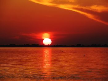 Scenic view of sea against romantic sky at sunset