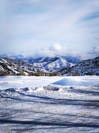 Scenic view of snow covered mountains against sky