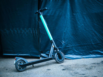 Electric push scooter parked on road