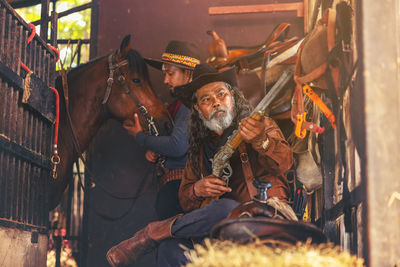 Rear view of man working at market