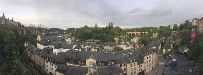View of cityscape against cloudy sky